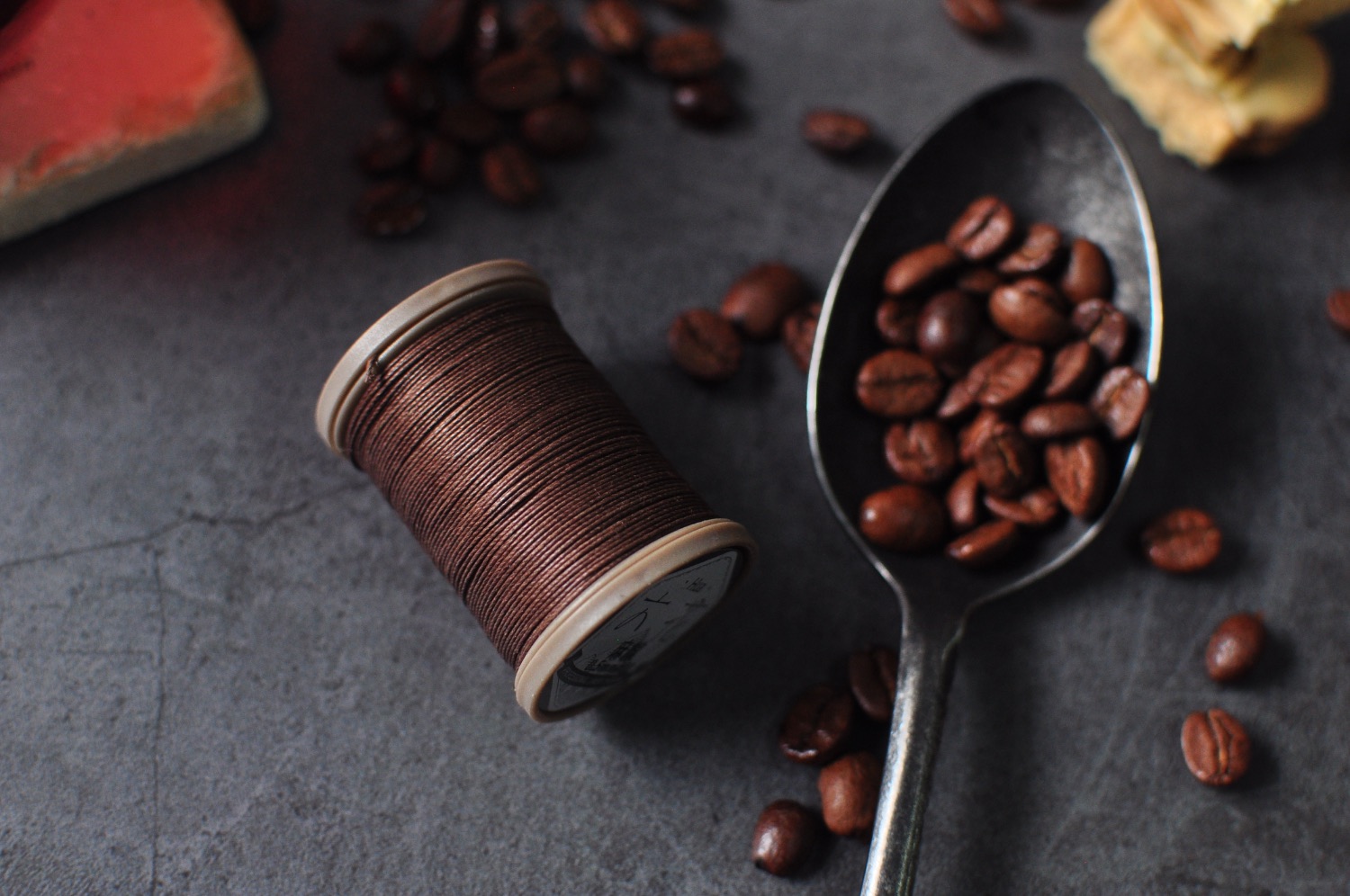 Spools of waxed hand-stitching thread in many colors — linen and braided thread for leatherwork